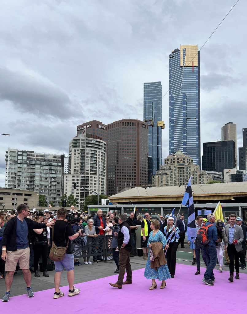 The horses owners and other hangers on walking up the carpet.